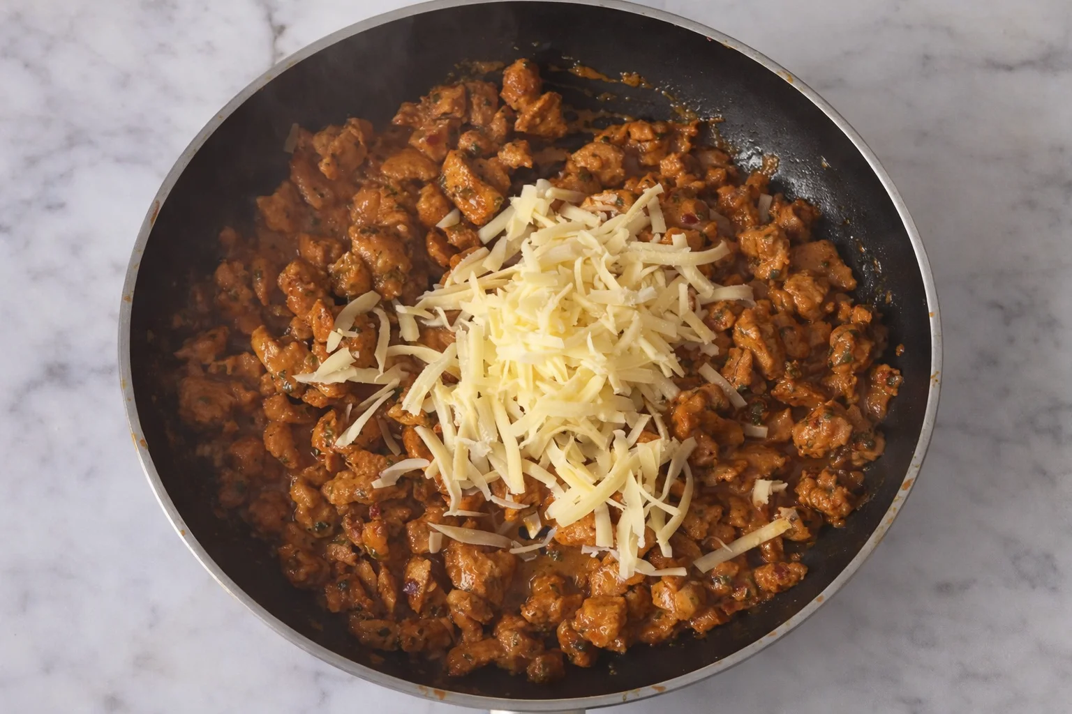 White rolls hollowed and filled with creamy chicken mixture in baking dish