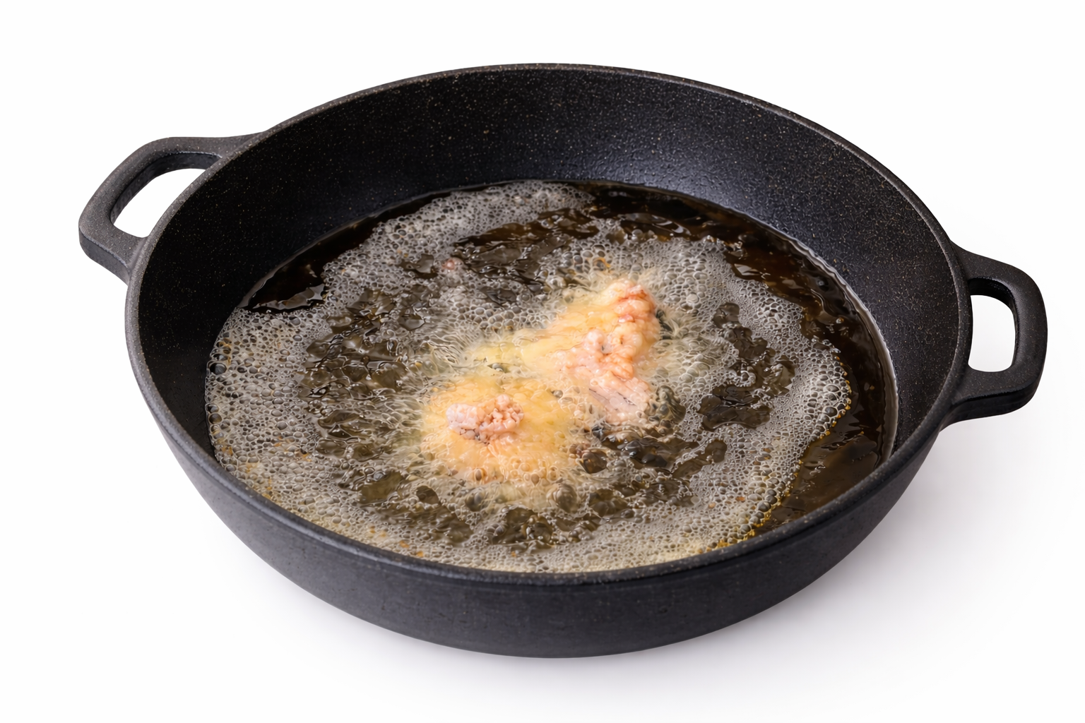 Chicken pieces frying in hot oil until golden
