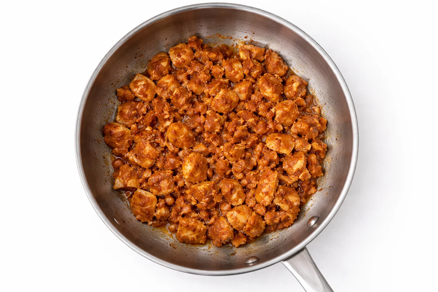 Seasoned chicken cooking in a skillet until browned and fully cooked for homemade crispy chicken quesadillas