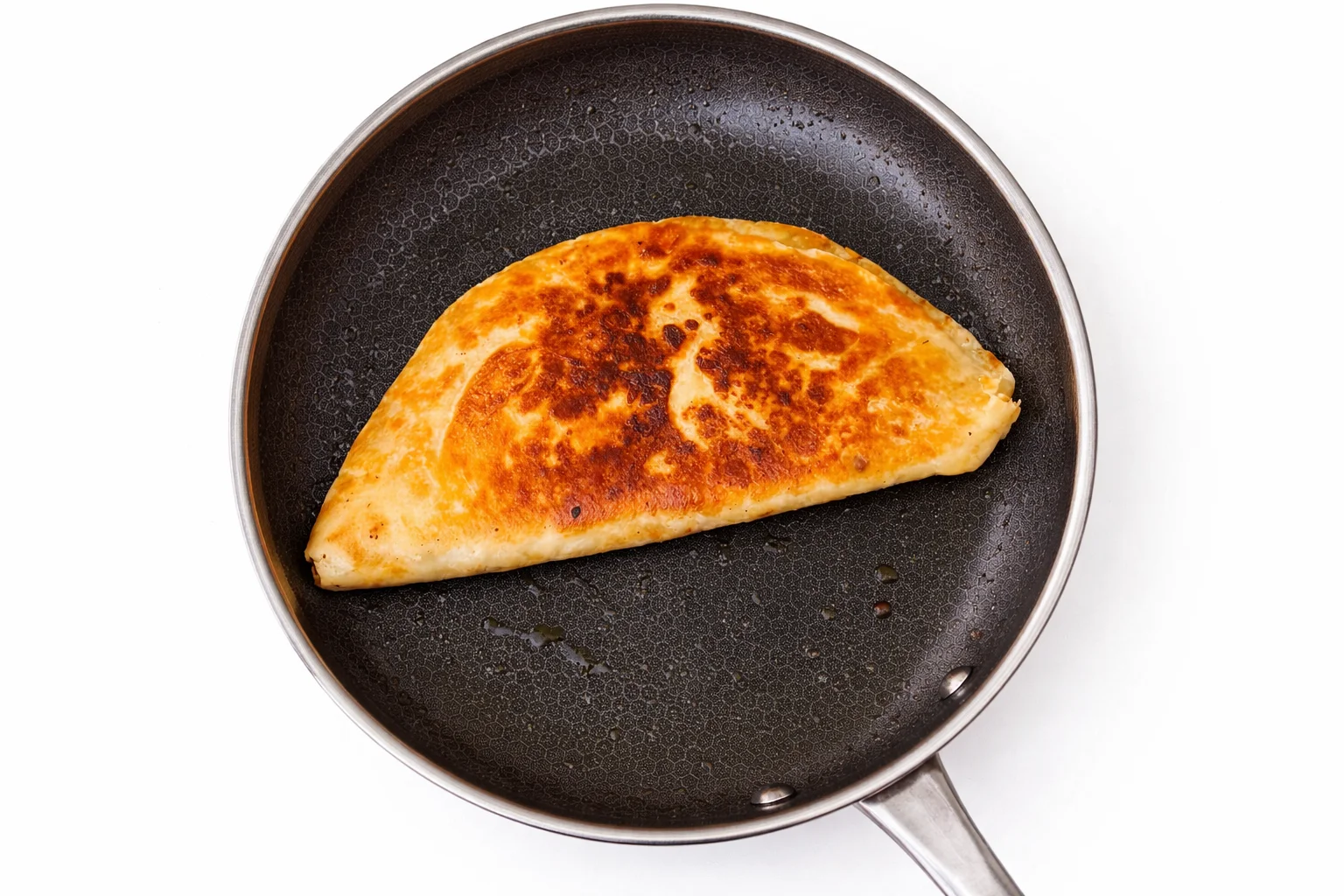 Golden crispy chicken quesadilla folded and cooked in skillet until toasted on both sides