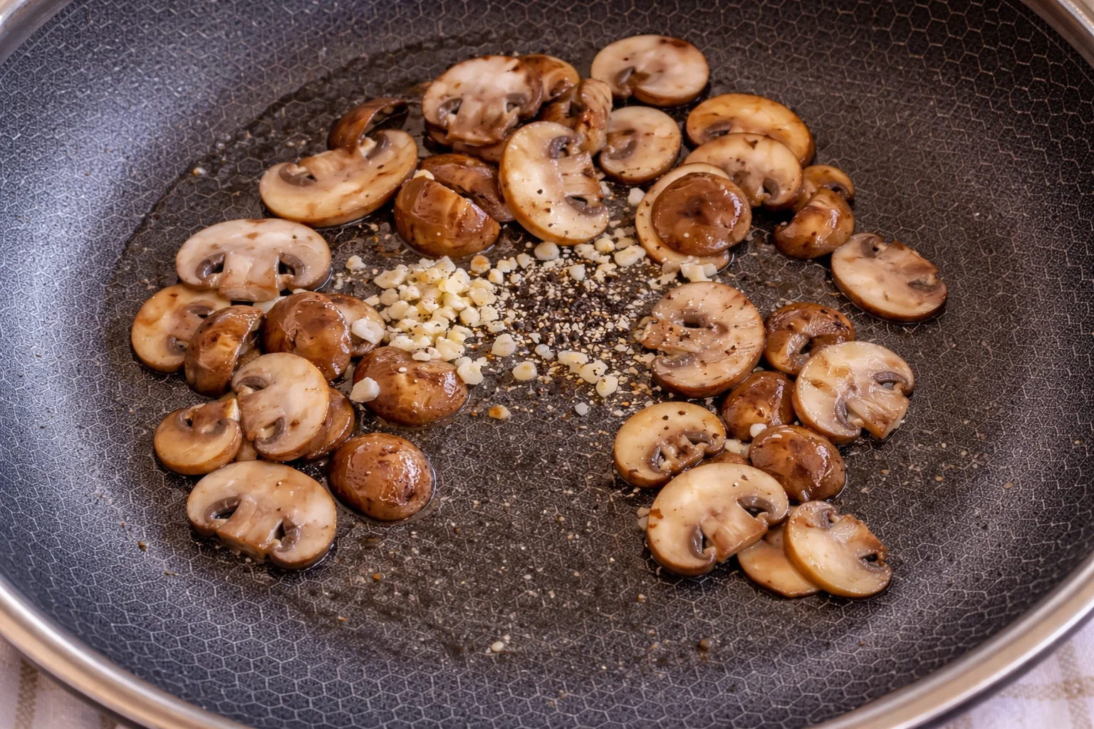 Mushrooms cooking in skillet until golden and caramelized