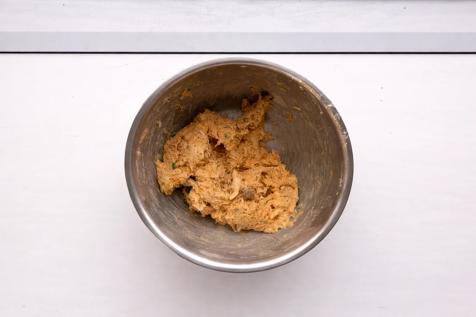 Creamy buffalo chicken filling fully mixed in bowl