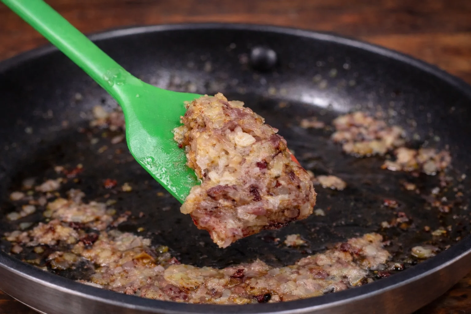 Mixing onions in skillet