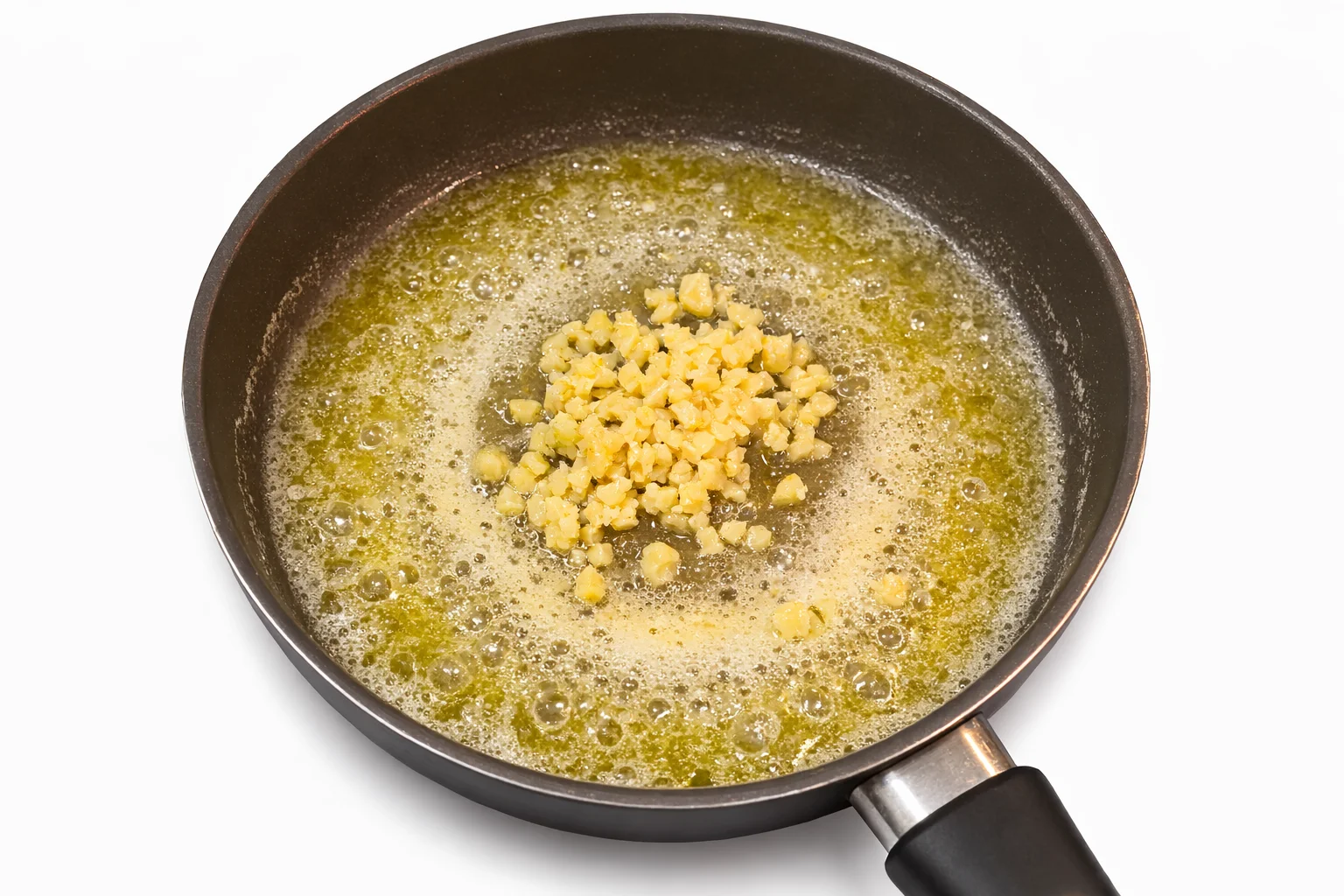 garlic cooking in melted butter in a skillet
