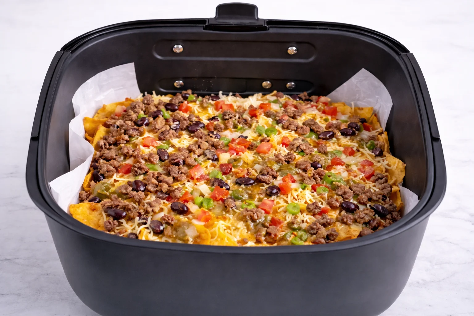 Fresh pico de gallo adds color brightness and a refreshing contrast to the warm cheesy layers.