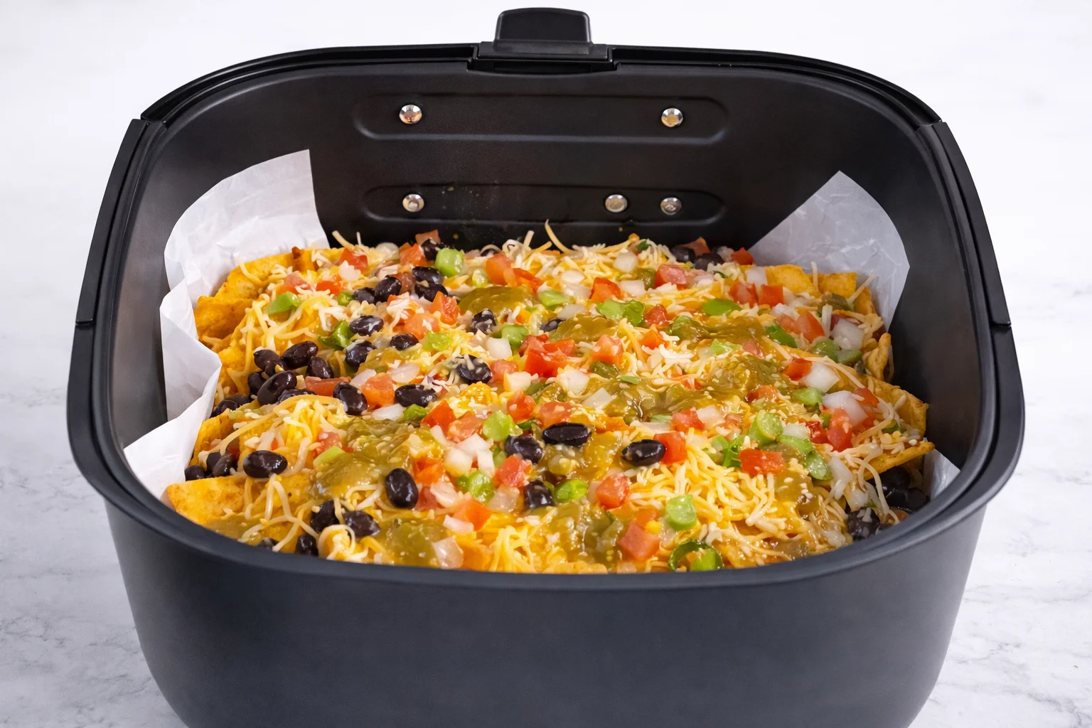 Jalapeños are scattered across the nachos for a spicy kick that balances the rich melted cheese.