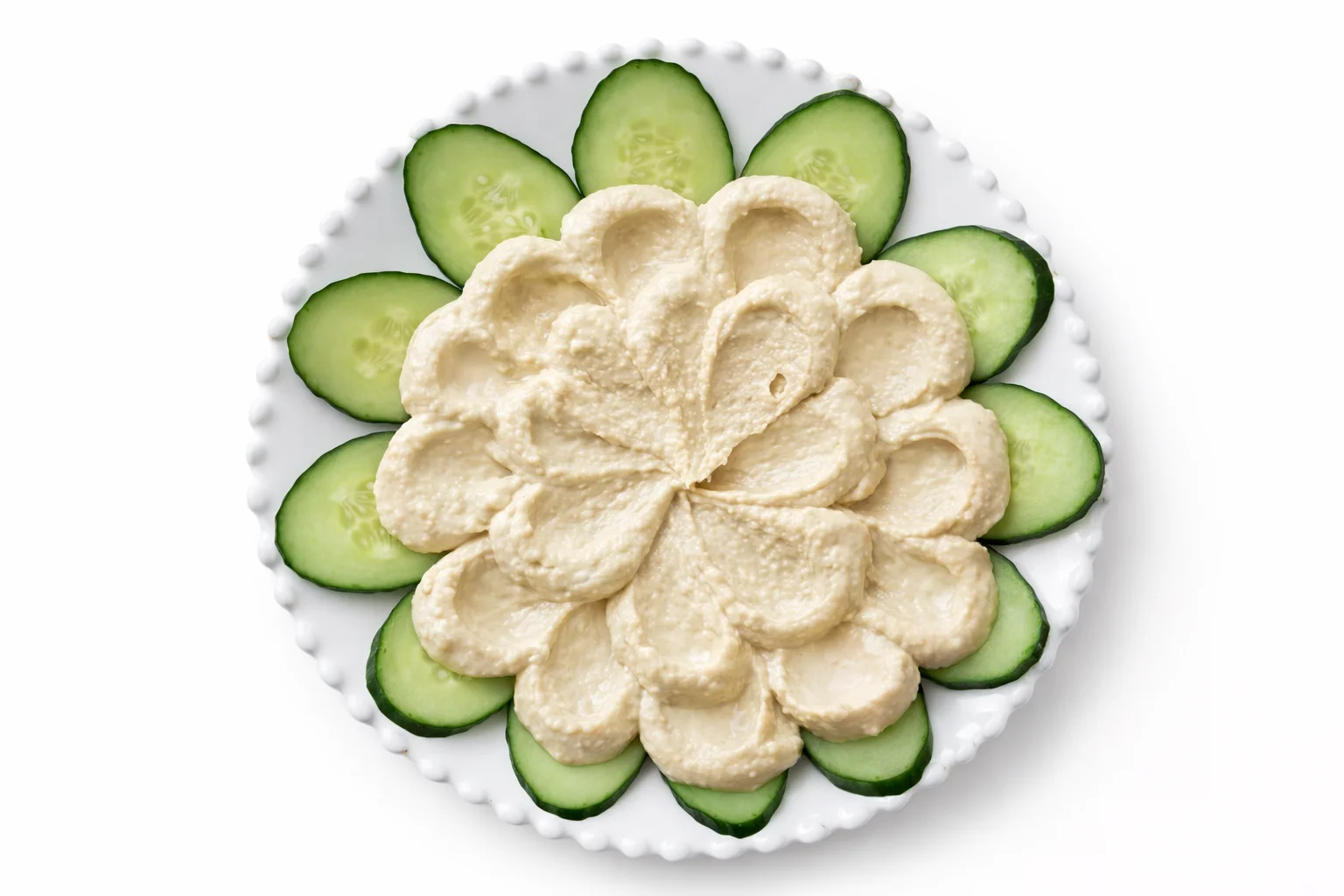 Creamy hummus spread on a serving platter to create the base for a hummus appetizer platter