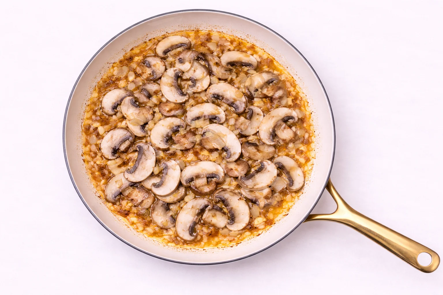 sliced mushrooms cooking in garlic sauce for tuscan chicken recipe