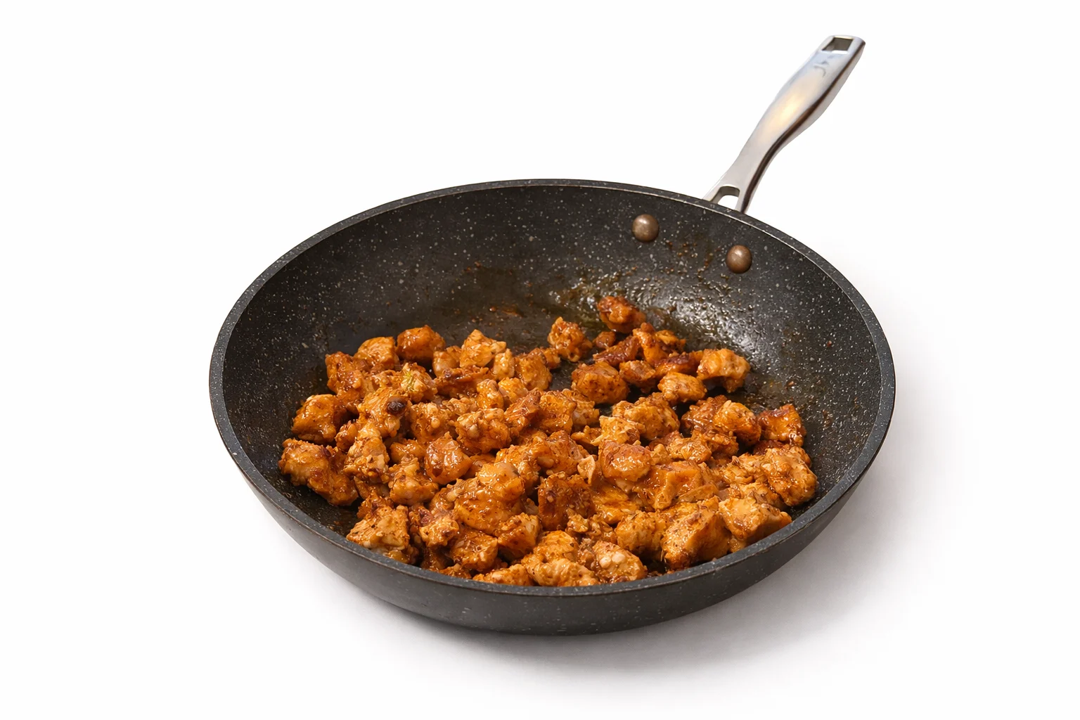 seasoned diced chicken cooking in a skillet until golden and lightly browned