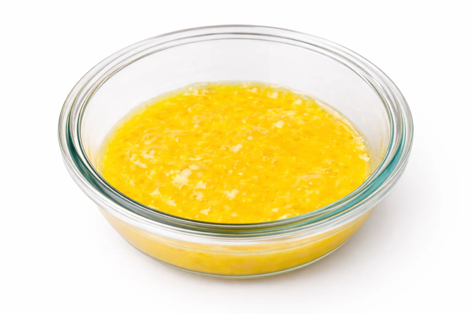 Whisked egg in a glass bowl used for breading mozzarella sticks before air frying