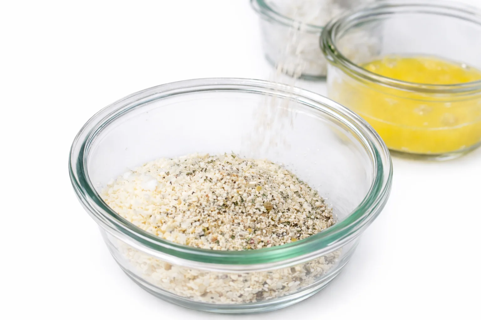 Seasoned breadcrumb mixture in a bowl for coating mozzarella sticks before air frying