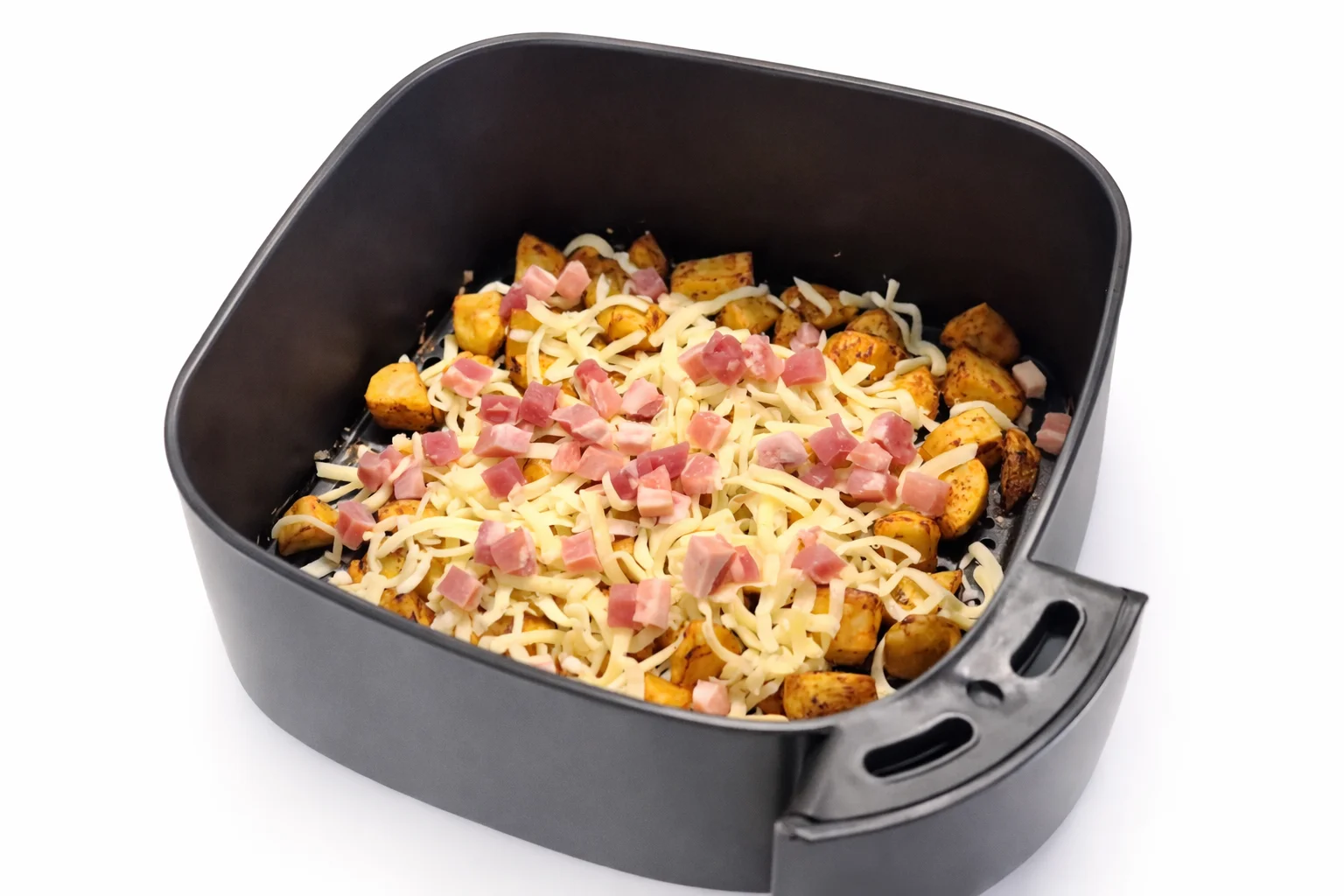 air fryer cheesy potato bites recipe step 4 adding shredded cheese and diced bacon on crispy potatoes