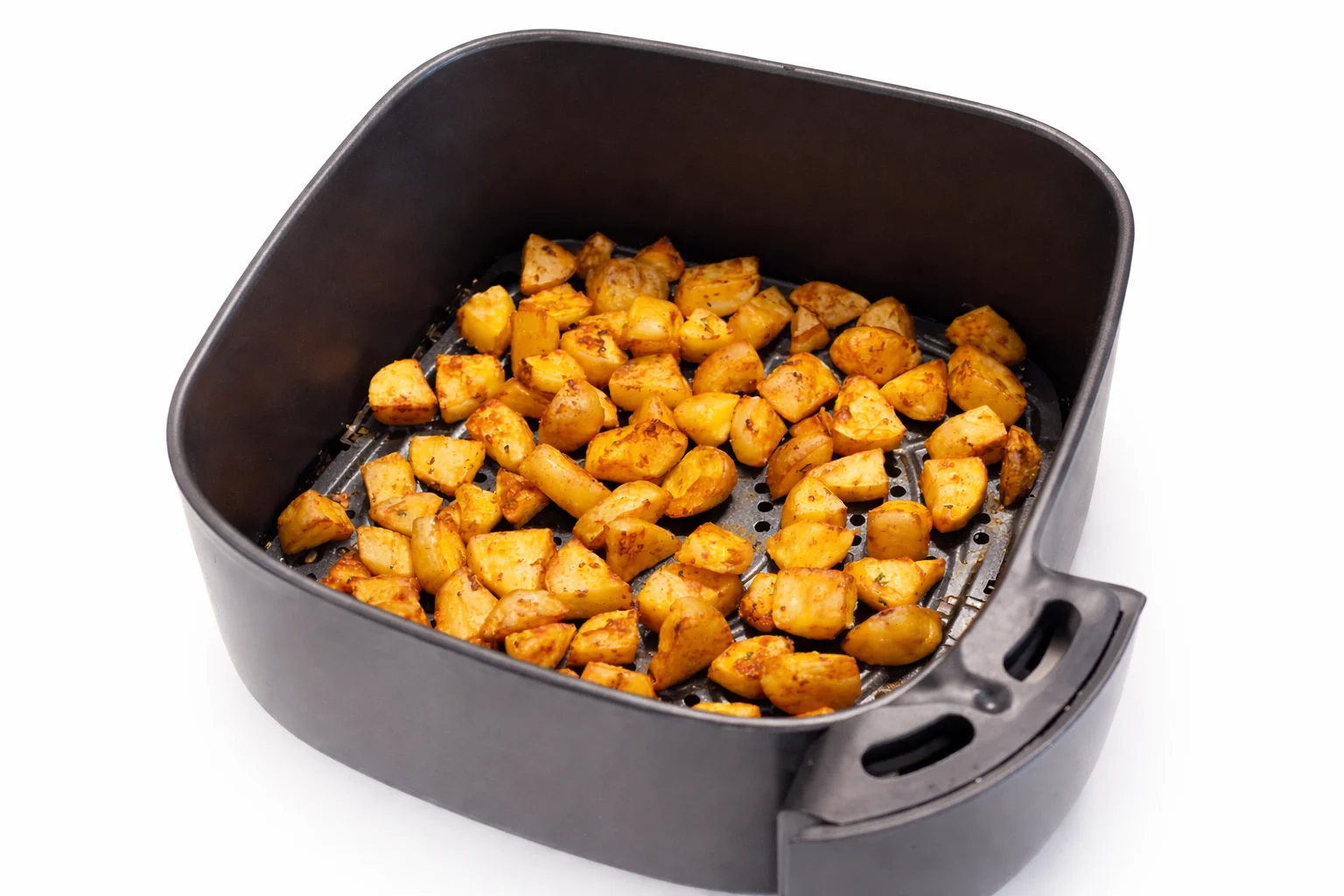 air fryer cheesy potato bites recipe step 3 seasoned potato cubes cooking in an air fryer basket