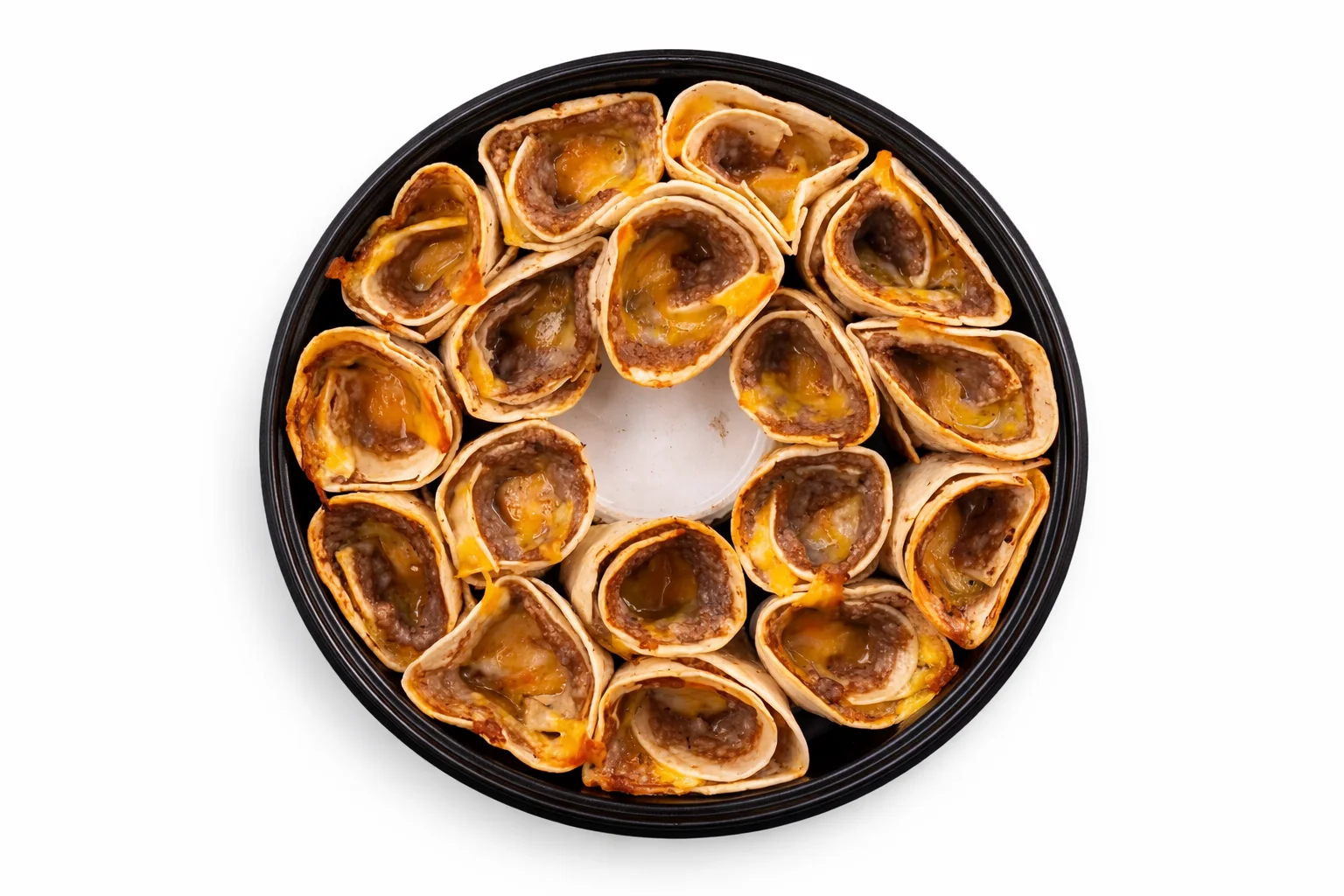 tortilla cones filled with sausage and cheese baking in a pan as the tortillas begin turning golden