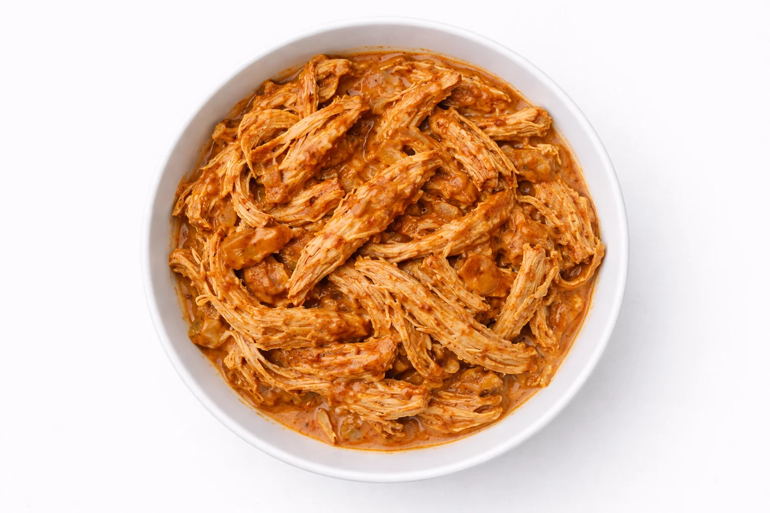 shredded chicken mixed with creamy buffalo sauce in a bowl