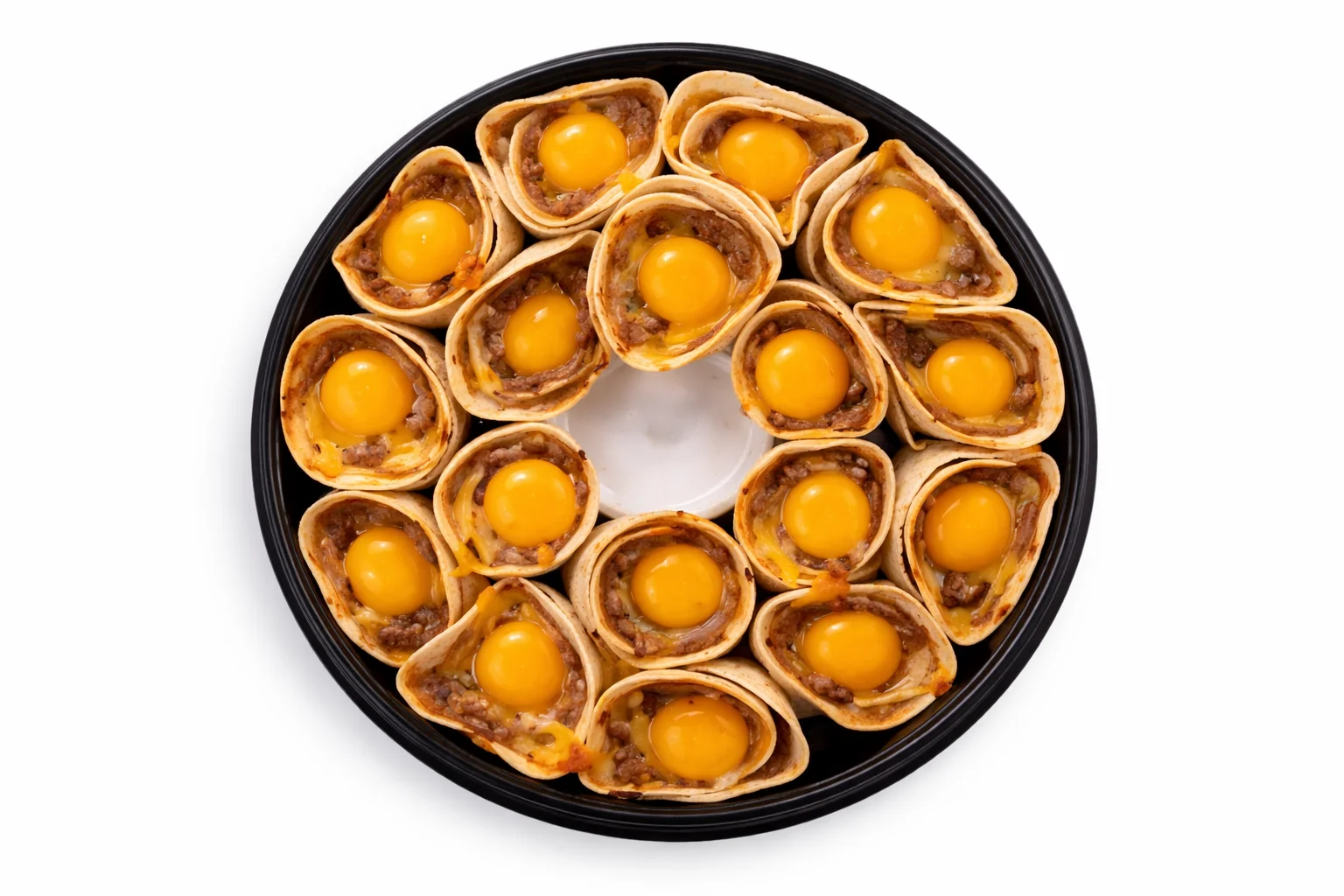 whole eggs cracked into tortilla cones filled with sausage and cheese before baking