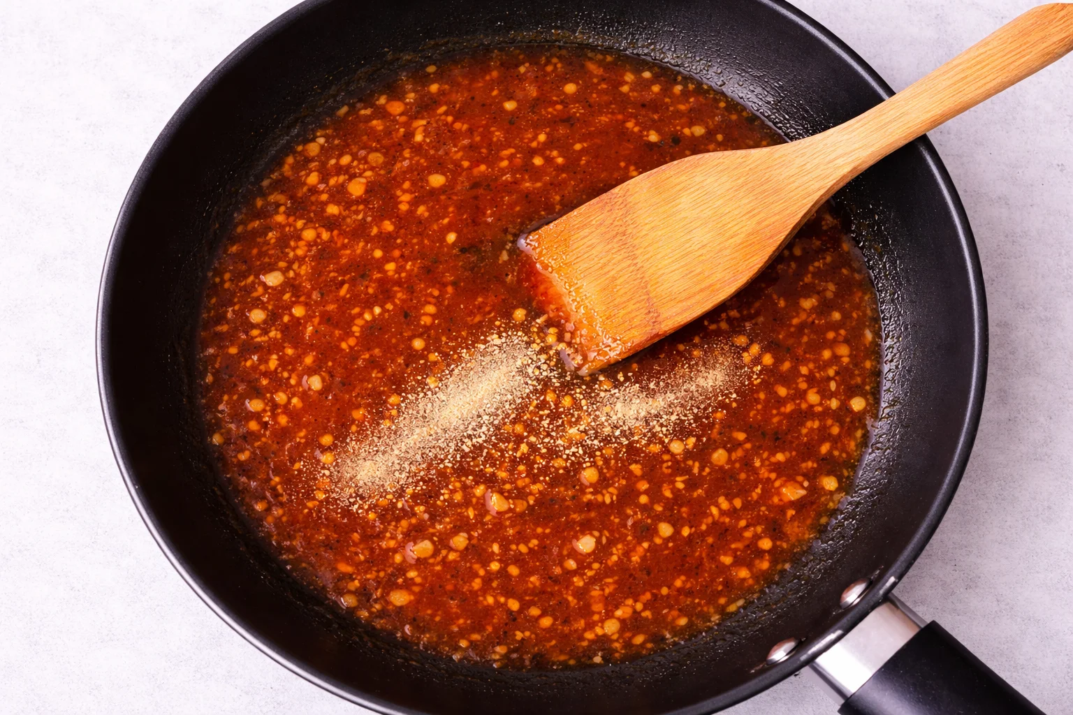 hot honey garlic sauce simmering in a pan