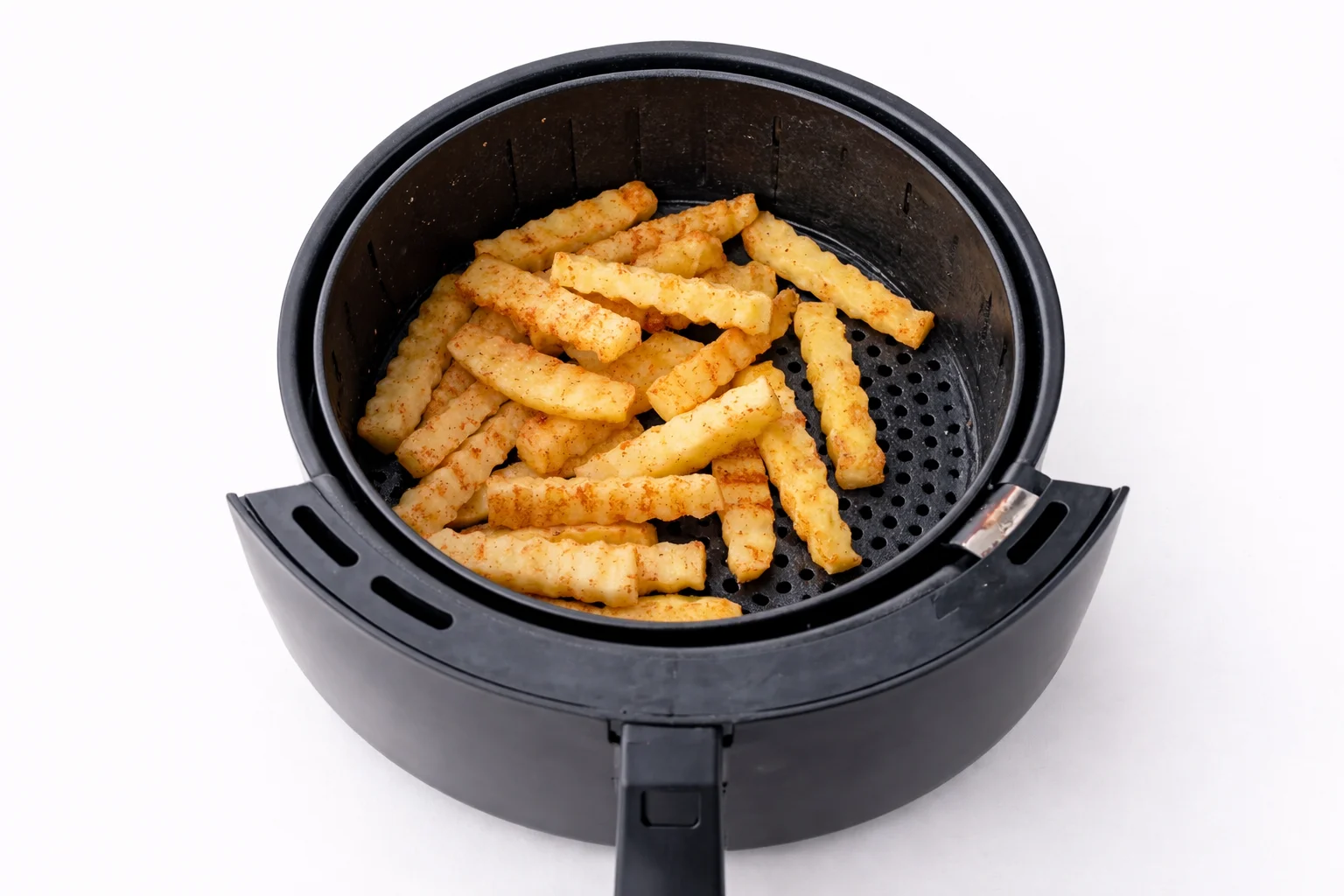 seasoned crinkle cut fries cooking in an air fryer basket
