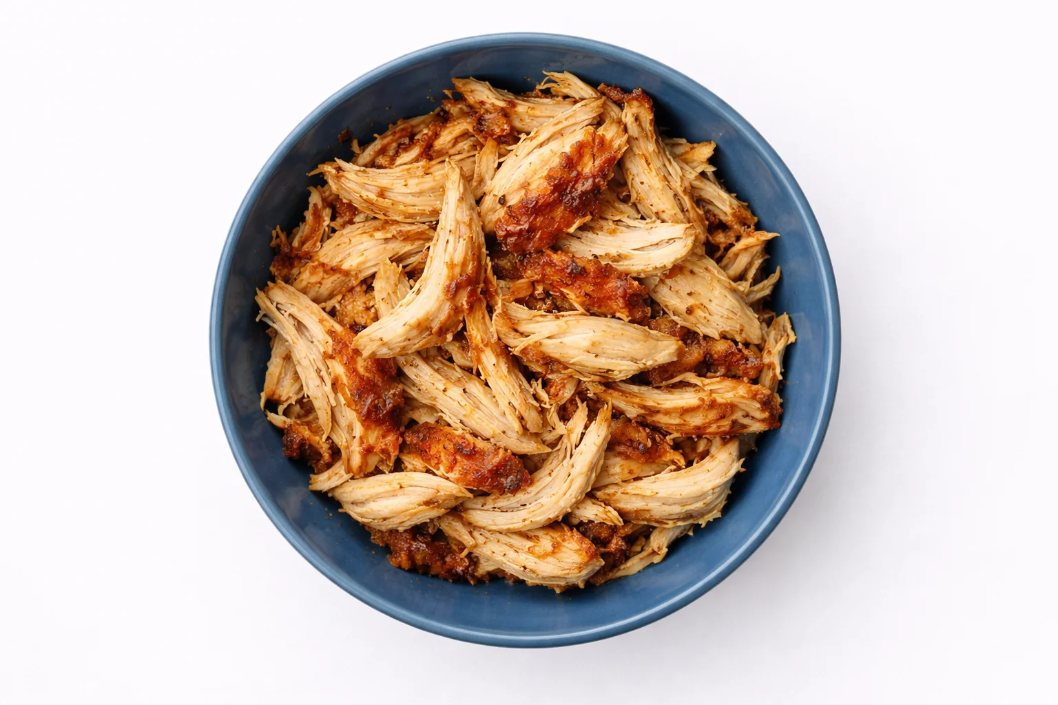 cooked chicken breast shredded into pieces in a bowl