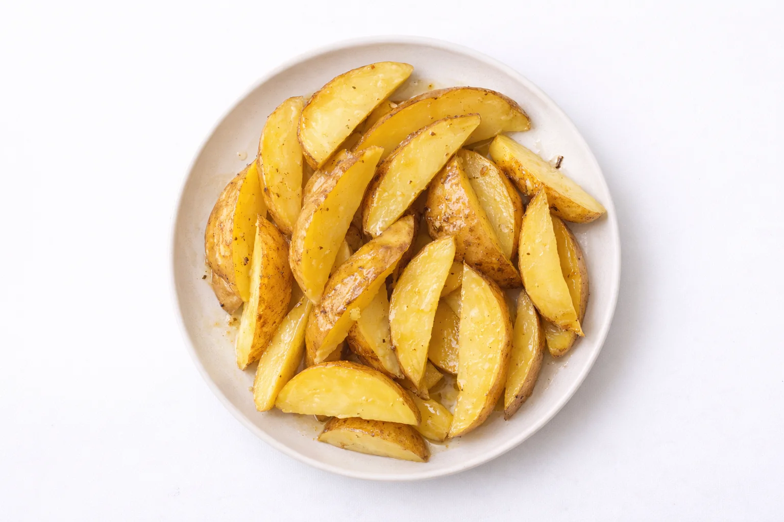 fresh potato wedges tossed with olive oil before seasoning