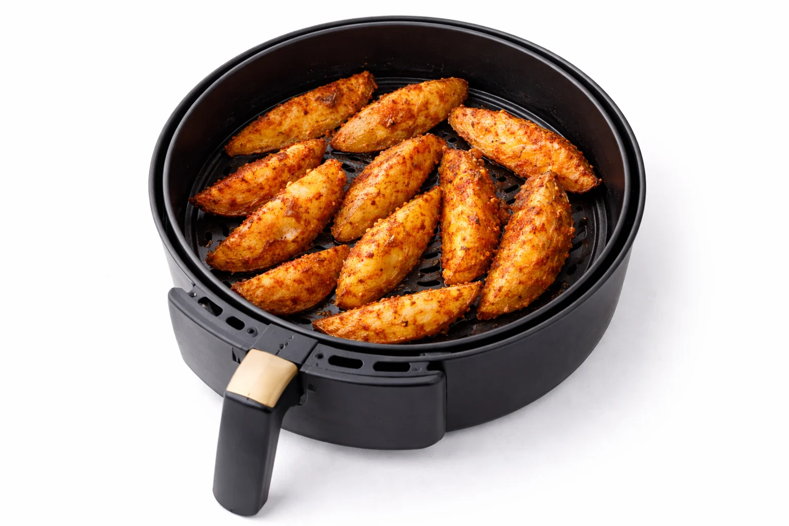 seasoned potato wedges cooking in air fryer basket